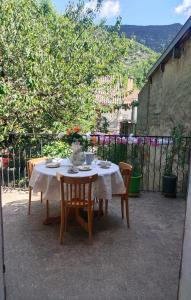 a table with chairs and a white table cloth on it at Chez jacky in Serres