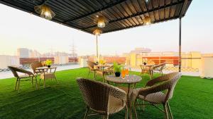a patio with tables and chairs on a roof at ZEN Medicity - Boutique Hotel Gurgaon in Gurgaon