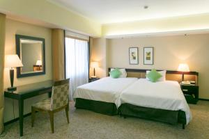 Postel nebo postele na pokoji v ubytování Kanazawa New Grand Hotel Prestige