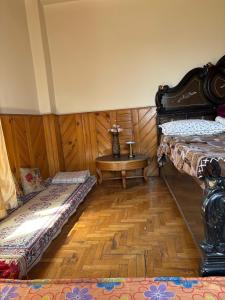 a room with two beds and a table in it at Walking Trails Homestay in Baragrān +2 photos