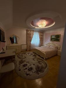 a bedroom with a bed and a chandelier at Luxury Apartaments 3 in Truskavets