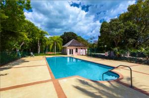 a swimming pool with a house in the background at The Blue Inn Family Vacation Rental in Smith Point