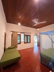 a living room with a bed and a window at Mariposa Hiriketiya in Dickwella