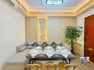 a dining room with a table and chairs at URBAN CHIC 1Bedroom Condo Unit at MesaVirre with PlayStation 5, Pool view, and Sunset view in Bacolod