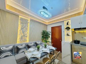 a dining room with a table and chairs in it at URBAN CHIC 1Bedroom Condo Unit at MesaVirre with PlayStation 5, Pool view, and Sunset view in Bacolod