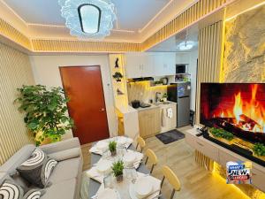 a living room with a large fireplace in a living room at URBAN CHIC 1Bedroom Condo Unit at MesaVirre with PlayStation 5, Pool view, and Sunset view in Bacolod