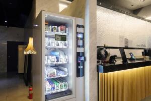 a refrigerator is open with drinks in it at 동대문 벨루스 호텔 in Seoul