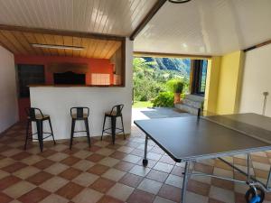 a dining room with a table and two chairs at le ti coin papi hugues in La Plaine des Palmistes +10 photos