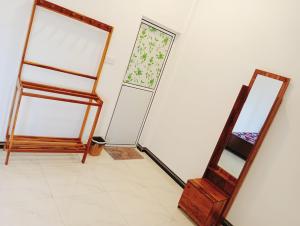 a room with two mirrors on the wall at Mano Holiday Guest House in Kalkudah