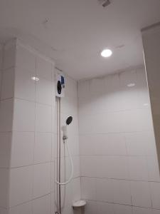 a white bathroom with a shower and a toilet at Silver Oaks Hotel in Patong Beach +21 photos