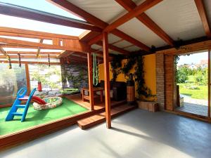 a room with a porch with a slide and a playground at Apartmán U Tří Palem in Břeclav