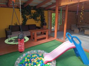 a play room with a pile of balls and a slide at Apartmán U Tří Palem in Břeclav