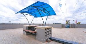 a blue umbrella sitting on top of a bench at Bnb syokimau in Syokimau