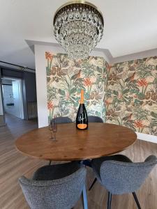 a dining room table with a bottle of wine on it at CASAMA am See in Langenargen