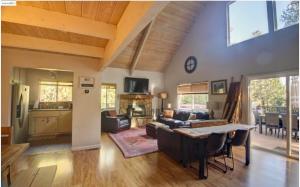 a living room with a couch and a table at Large Deck & Spa & Games & Vaulted Ceiling Cabin in Groveland