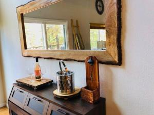 a mirror on top of a dresser with a pot at Large Deck & Spa & Games & Vaulted Ceiling Cabin in Groveland +30 photos