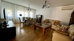 a living room with a couch and a table at AMANECER ZEN in Argés