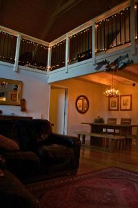 a living room with a couch and a table at Large Deck & Spa & Games & Vaulted Ceiling Cabin in Groveland