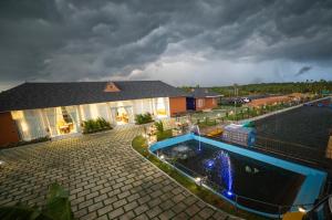 a house with a swimming pool in front of a building at S Cross Munroe Island Resort in Munroe Island