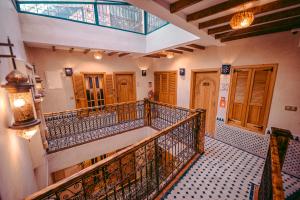 a staircase in a building with wooden doors at Riad Bleu Azahraa in Safi +94 photos