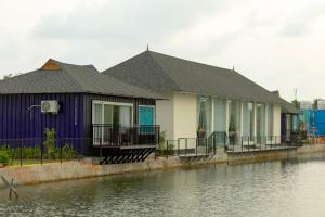 a house next to a body of water at S Cross Munroe Island Resort in Munroe Island