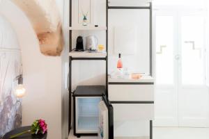 a room with a shelf with a computer on it at Monsignore Luxury Suite in Monopoli
