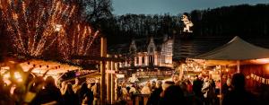 a crowd of people walking around a market at night at Escape at Durbuy in Durbuy +53 photos