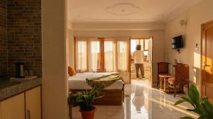 a bedroom with a bed and a person looking out the window at Kalra Regency Shimla in Shimla