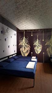 a bedroom with two beds and a wall with art on it at Hills Queen Resort And Camping in Mohan Chatti +33 photos