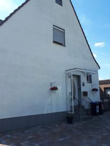 a white building with a door and a window at Ferienwohnung Sofia in Marl
