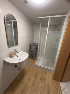 a bathroom with a sink and a shower at Ferienwohnung Sofia in Marl