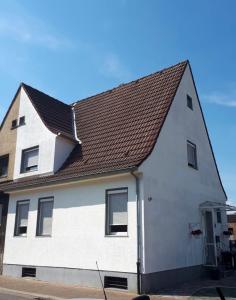 a white house with a brown roof at Ferienwohnung Sofia in Marl