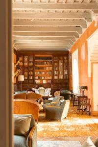 a large living room with couches and books at Palacio de los Leones in Lora del Río