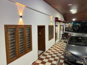 a car parked in a garage next to a car dealership at AMAN Residency in Kallar Vattiyar