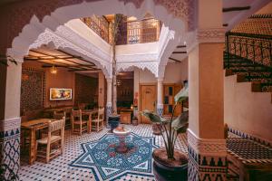a lobby of a building with a table and chairs at Riad Bleu Azahraa in Safi