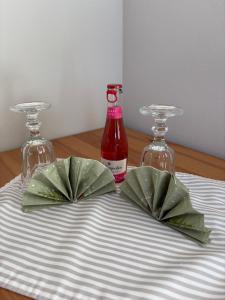 a table with two wine glasses and a bottle at Ferienhaus SüdWest in Bosau +37 photos