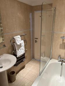 a bathroom with a shower and a sink at Aigua Blava in Carbis Bay