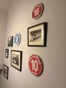 a wall with plates and pictures on a wall at Charmante chambre Chalet in Crozet +3 photos