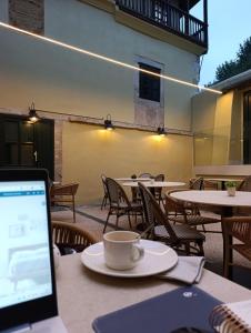 a laptop computer sitting on a table with a cup of coffee at U-Hotel Aduana Ribadeo in Ribadeo