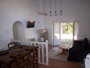 a living room with a table and a couch at Le soleil in Chabanais