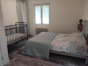 a bedroom with a bed and a window at Le soleil in Chabanais