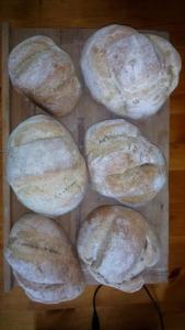 a group of loaves of bread on a wooden table at Le soleil in Chabanais +17 photos