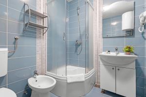 a bathroom with a shower and a toilet and a sink at LotusApart in Premantura +38 photos