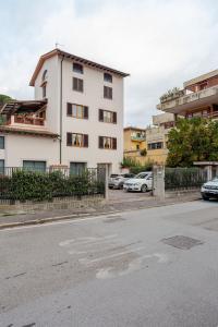 a white building with cars parked in a parking lot at Signa, Firenze Casa Pilade in Signa