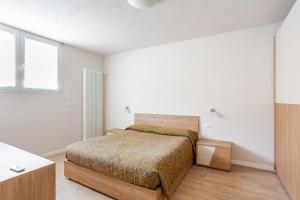 a white bedroom with a bed and a window at Signa, Firenze Casa Pilade in Signa