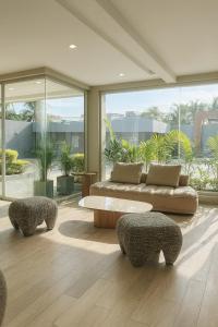 a living room with a couch and two chairs at Tibisay Hotel Boutique Morrocoy in Tucacas +4 photos