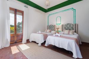 a bedroom with two beds and a mirror on the wall at Panther Home El Ancla Villa Premium con Piscina Privada in El Puerto de Santa María +106 photos