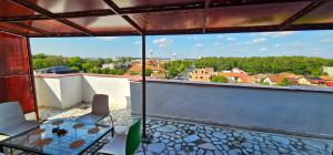 a balcony with a table and chairs and a view at Apartament Vasy in Timişoara