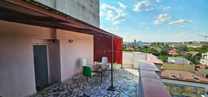 a balcony with chairs and a view of a city at Apartament Vasy in Timişoara