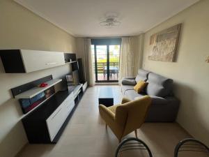 a living room with a couch and a tv at Paraiso Spa Reinante in San Miguel de Reinante